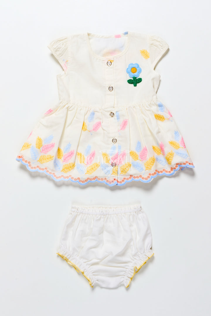 Cream Baby Frock with Pastel Thread Embroidery and Flower Patch