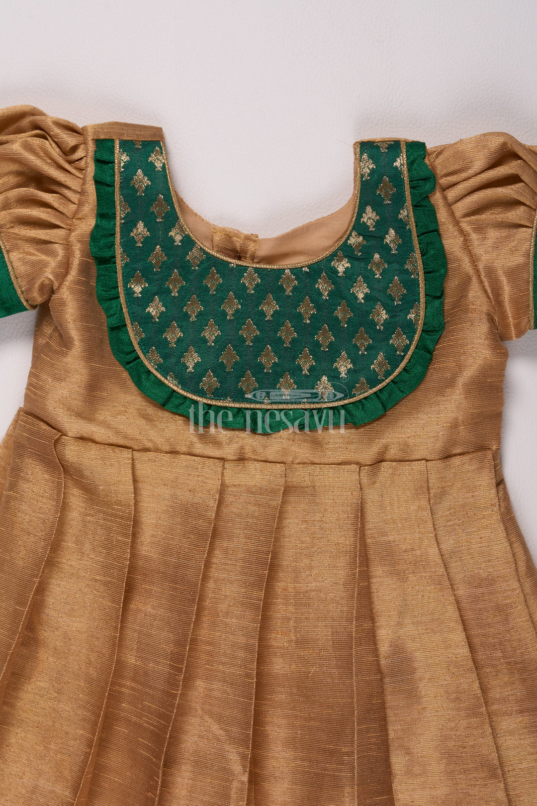 Radiant Gold Long Frock Pattu for Girls with Green Bib Yoke and Silver Tissue Fabric