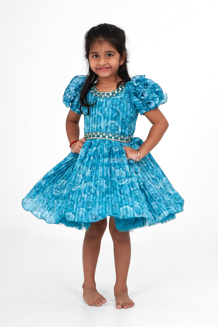 Girls Fancy Frock in Blue Organza Printed Fabric with Puff Sleeves and Floral Embellishments