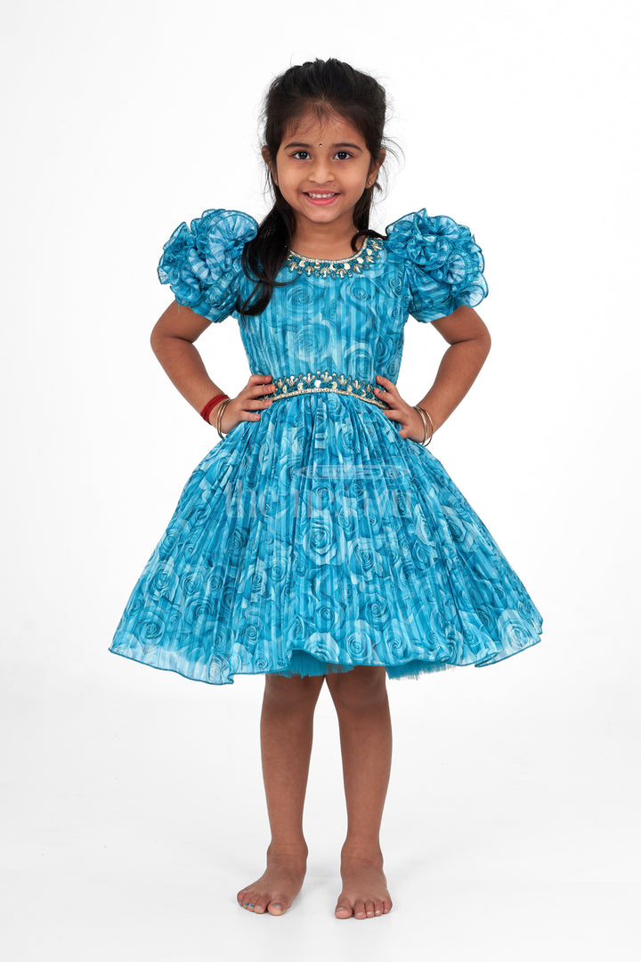 Girls Fancy Frock in Blue Organza Printed Fabric with Puff Sleeves and Floral Embellishments