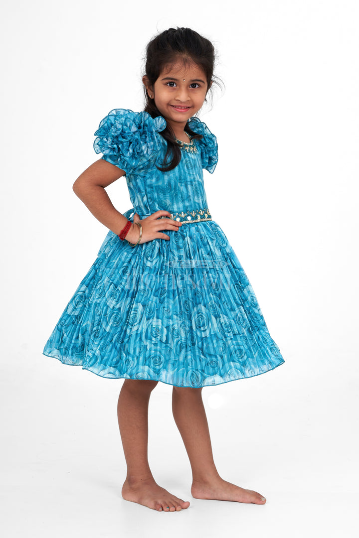 Girls Fancy Frock in Blue Organza Printed Fabric with Puff Sleeves and Floral Embellishments