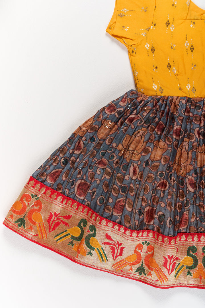 Girls Yellow Pattu Pavadai with Traditional Printed Border and Contrast Skirt for Festive Wear