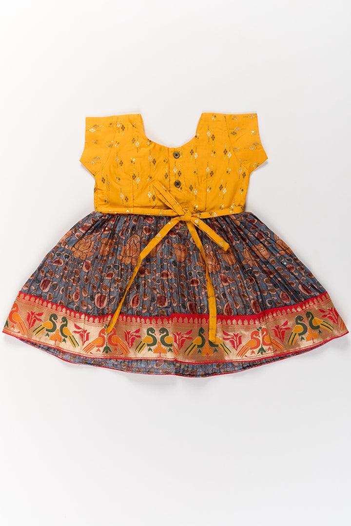 Girls Yellow Pattu Pavadai with Traditional Printed Border and Contrast Skirt for Festive Wear