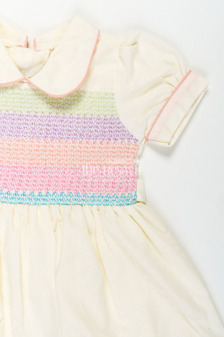 The Nesavu Girls Cotton Frock Archive -Girls Short Frock White Colour with Smocked Rainbow Yoke and Peter Pan Collar in Soft Cotton Blend Nesavu Nesavu Girls Short Frock White Colour Rainbow Smocked Yoke Peter Pan Collar