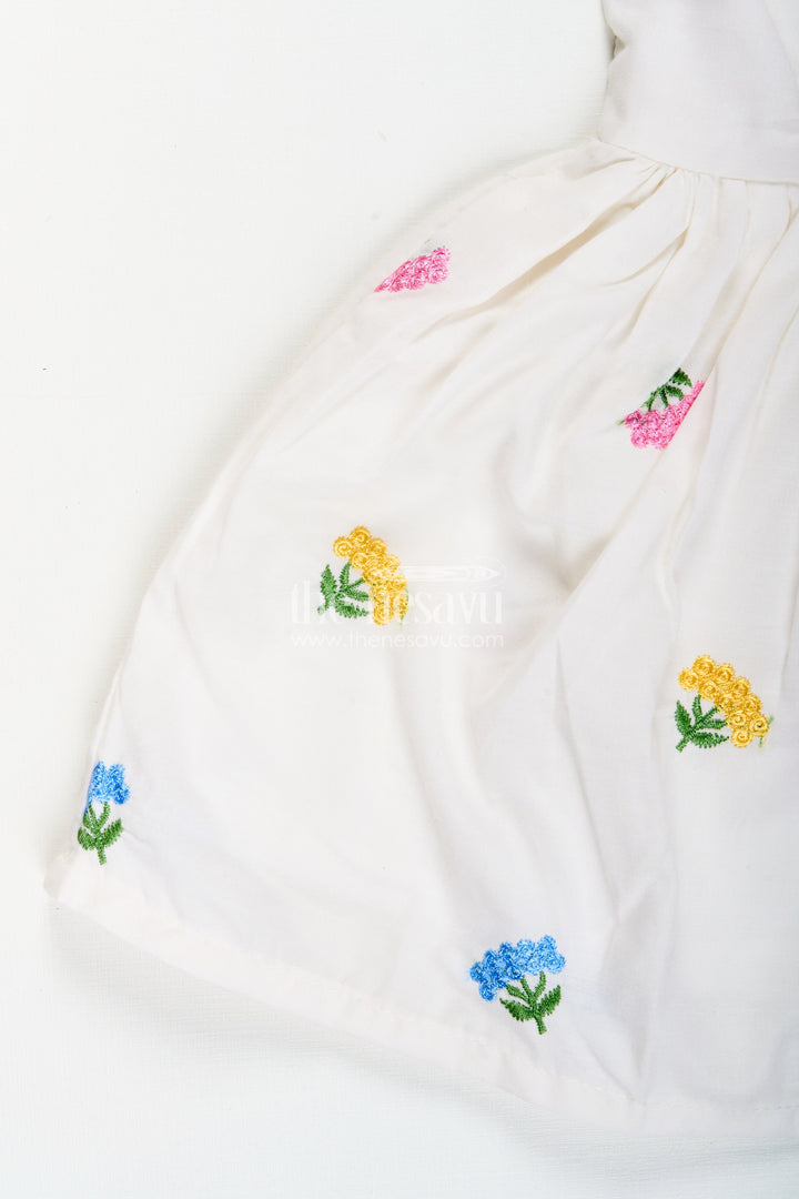 The Nesavu Baby Cotton Frocks Baby girl white cotton frock with floral embroidery for casual outings Nesavu Nesavu baby girl white cotton frock with pastel floral embroidery for casual summer days