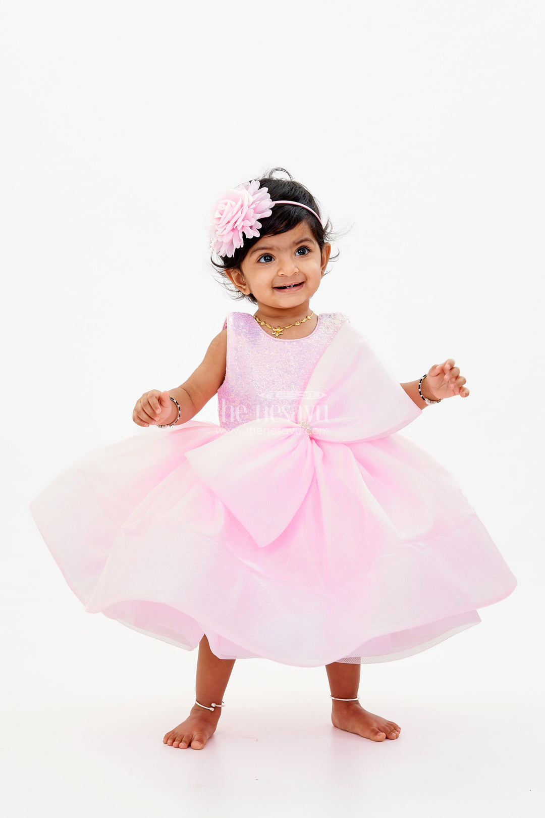 The Nesavu Baby Fancy Frock Baby Girls Fancy Frock in Pink Shimmer Fabric with Oversized Bow and Flared Silhouette Nesavu 16 (1Y) / Pink PF201B-16 Baby Girls Fancy Frock Pink Shimmer Fabric Oversized Bow Flared Skirt | The Nesavu