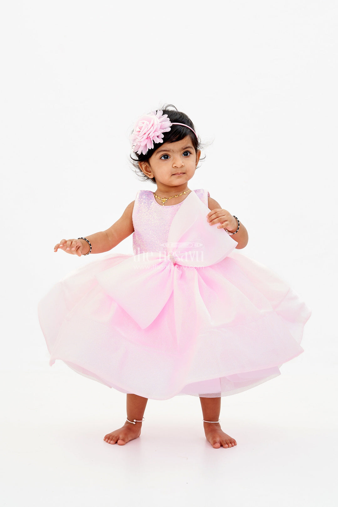 The Nesavu Baby Fancy Frock Baby Girls Fancy Frock in Pink Shimmer Fabric with Oversized Bow and Flared Silhouette Nesavu Baby Girls Fancy Frock Pink Shimmer Fabric Oversized Bow Flared Skirt | The Nesavu