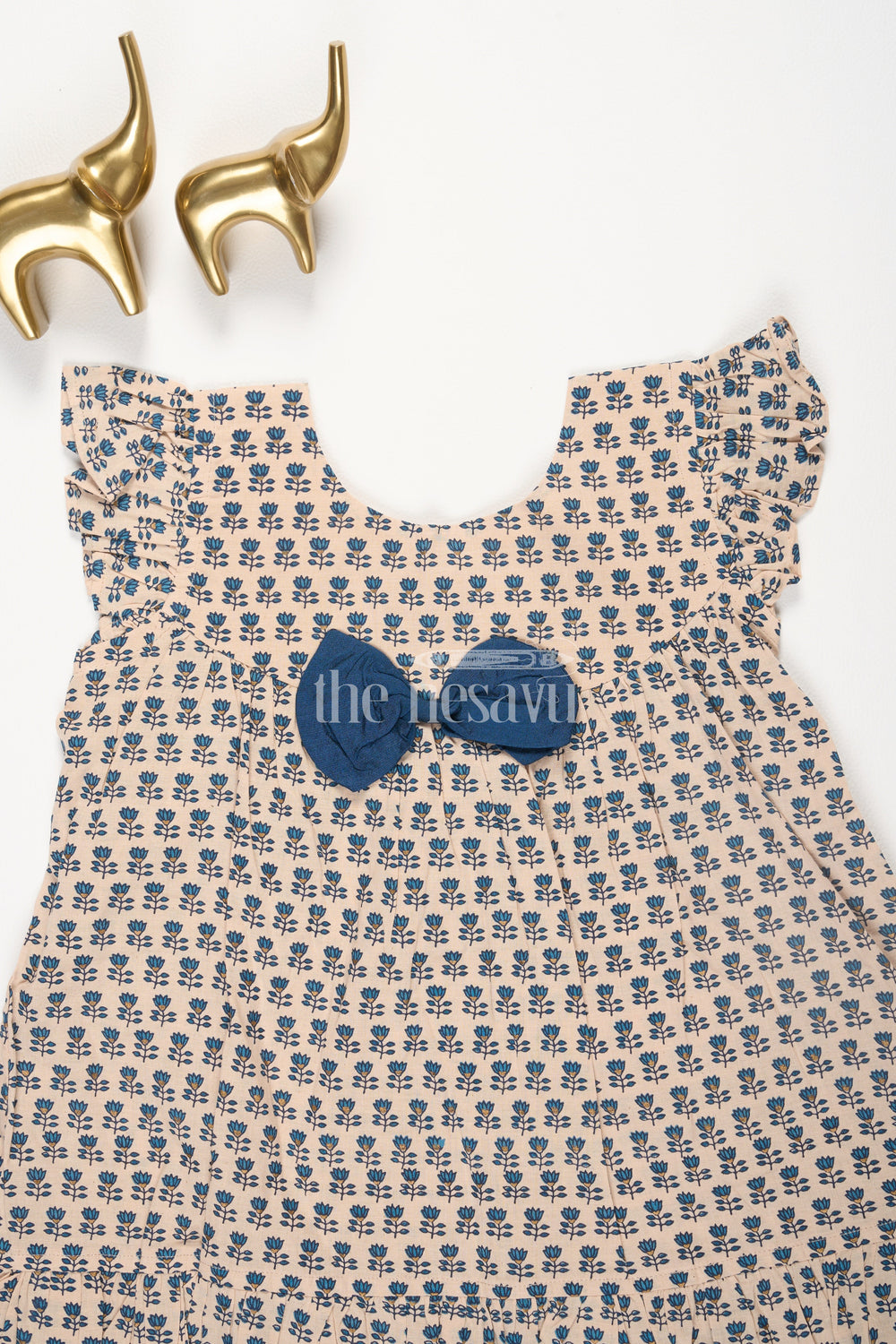 The Nesavu Baby Cotton Frocks Beige Cotton Baby Frock with Navy Blue Prints and Bow Accent Nesavu Beige Cotton Baby Frock with Navy Blue Prints and Bow Accent Nesavu