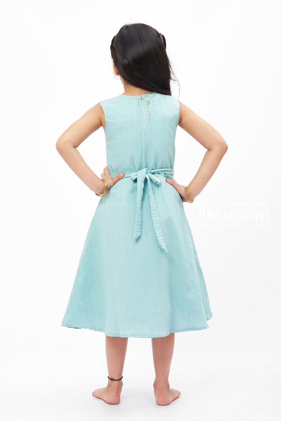 The Nesavu Girls Fancy Frock Blue Dream Pleated Frock: Refreshing Teal with Floral Accent for Girls Nesavu Girls' Teal Pleated Summer Dress | Sleeveless Floral Accent Frock | The Nesavu