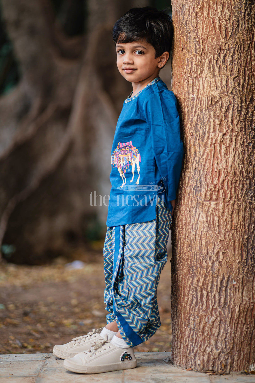 The Nesavu Boys Dothi Set Boys Blue Cotton Dhoti Set with Camel Print Kurta for Festive Occasions and Casual Gatherings Nesavu Nesavu Boys Blue Dhoti Set Chevron-Pattern Kurta Camel Print Festive Celebrations