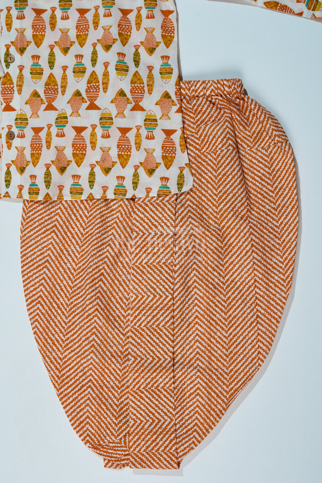 The Nesavu Boys Dothi Set Boys Designer Dhoti Kurta in Orange with Handcrafted Block Print Motifs Nesavu Boys Designer Dhoti Kurta Orange Fish Motif Chevron Dhoti | The Nesavu