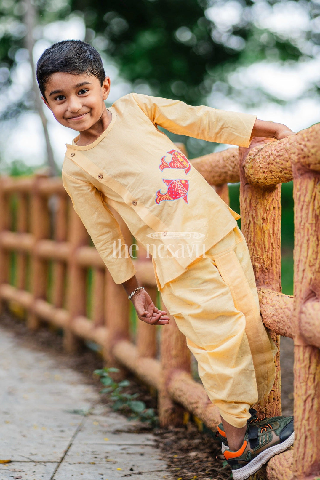 The Nesavu Boys Dothi Set Boys Yellow Cotton Dhoti Set with Vibrant Fish Motifs for Festive Events and Cultural Celebrations Nesavu Nesavu Boys Yellow Dhoti Set Fish Motifs Side-Button Kurta Festivals Celebrations