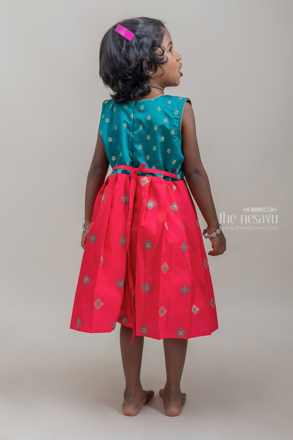 The Nesavu Silk Frock Captivating Green & Deeppink Butta Fusion Pleated Pattu Marvel for Girls. Nesavu Pink Semi-silk Frock For Girls | Latest silk wear Collection | The Nesavu