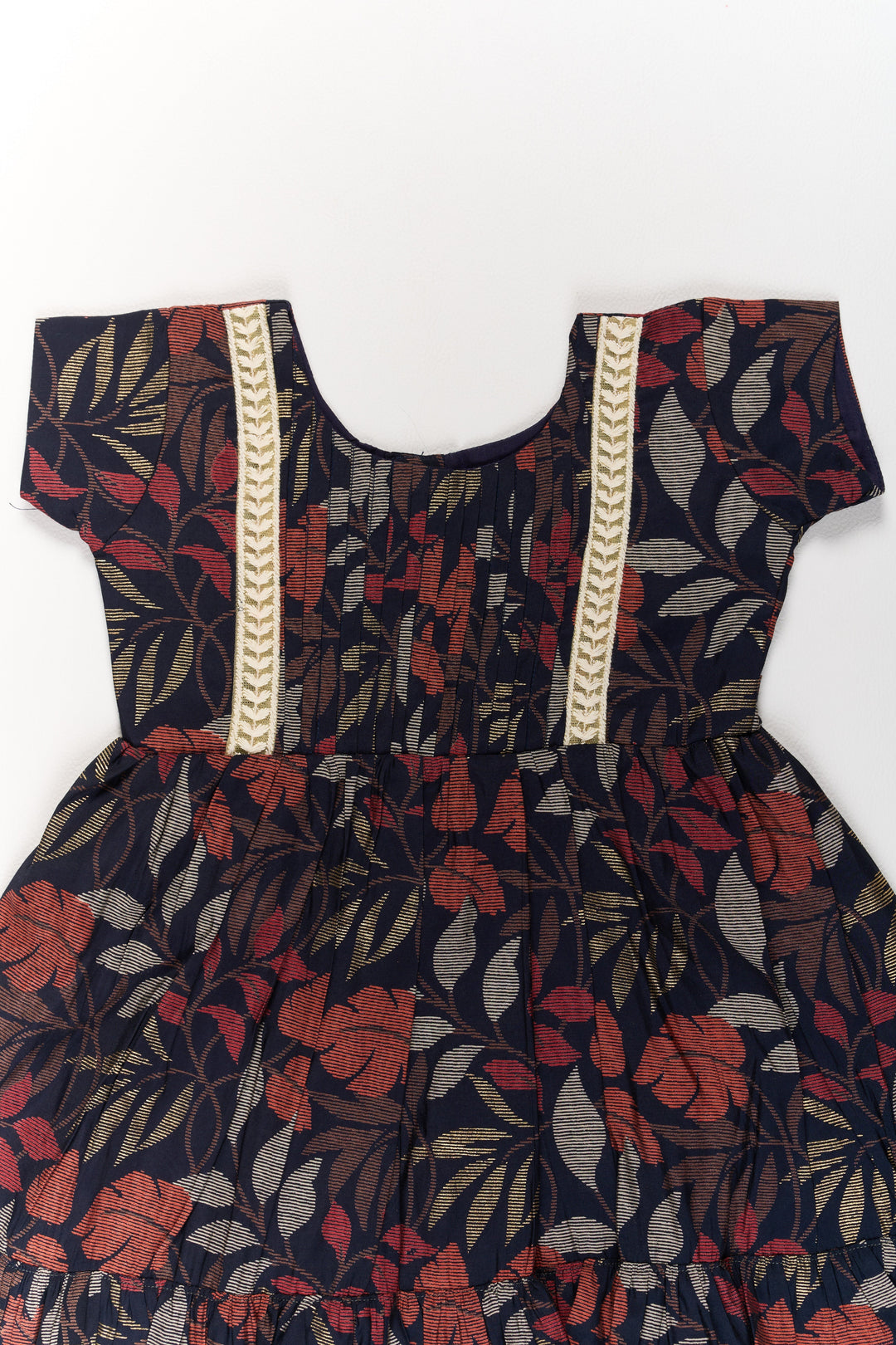 The Nesavu Girls Cotton Frock Charming Black Cotton Party Frock for Girls with Elegant Leaf Print and Frill Hem Nesavu Charming Black Cotton Party Frock Girls Elegant Leaf Print Frill Hem | The Nesavu