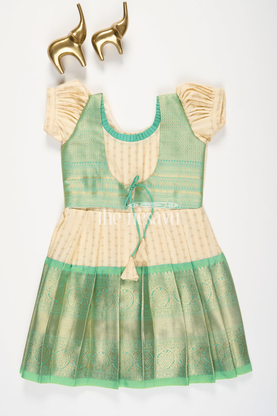 The Nesavu Girls Kanchi Silk Frock Cream and Green Semi Kanchivaram Silk Frock with Golden Stripes and Brocade Border for Girls Nesavu 20 (3Y) / Green / Style 2 SF862BB-20 Nesavu Cream Green Semi Kanchivaram Silk Frock Brocade Border Puff Sleeves Girls