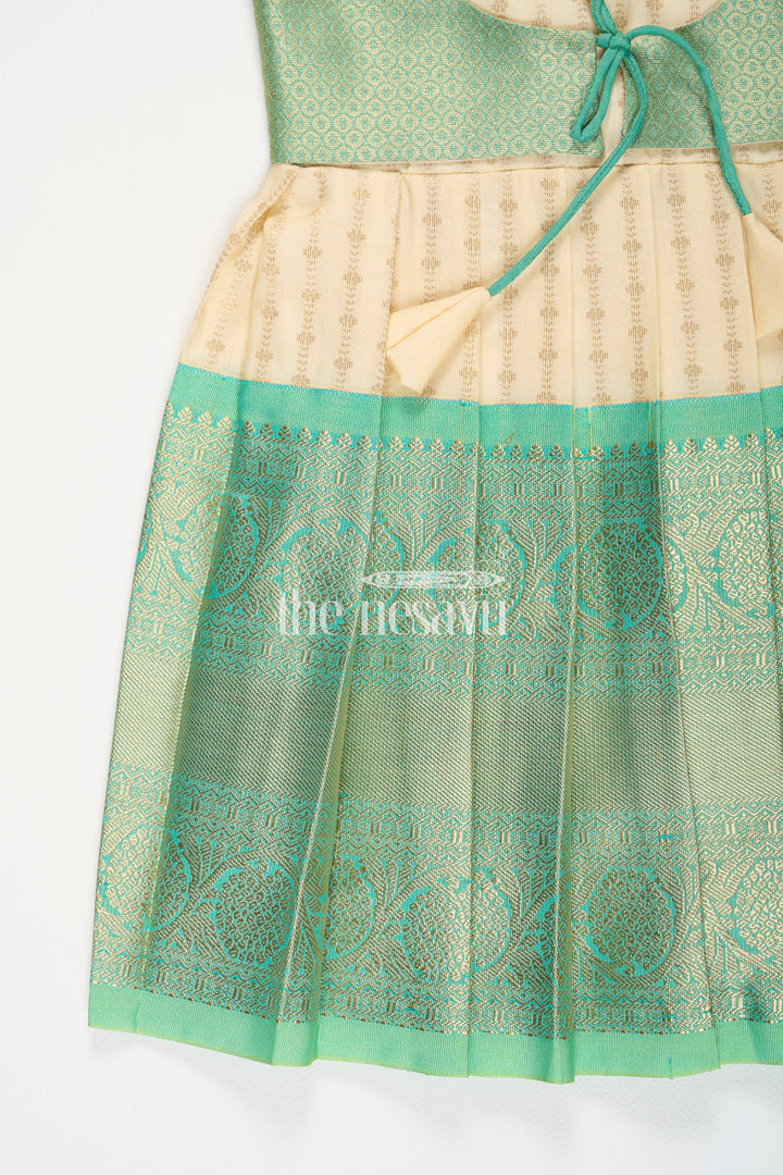 The Nesavu Girls Kanchi Silk Frock Cream and Green Semi Kanchivaram Silk Frock with Golden Stripes and Brocade Border for Girls Nesavu Nesavu Cream Green Semi Kanchivaram Silk Frock Brocade Border Puff Sleeves Girls