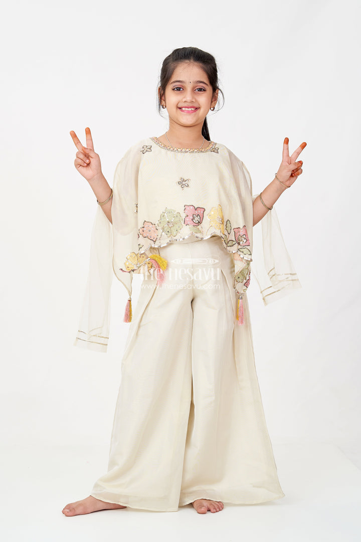 The Nesavu Girls Sharara / Plazo Set Cream Color Sharara Set for Girls in Shimmer Viscose Silk with Designer Embroidered Cape and Tassels Nesavu 16 (1Y) / Cream GPS599A-16 Girls Cream Color Sharara Set Embroidered Shimmer Cape Top Flared Silk Pants | The Nesavu