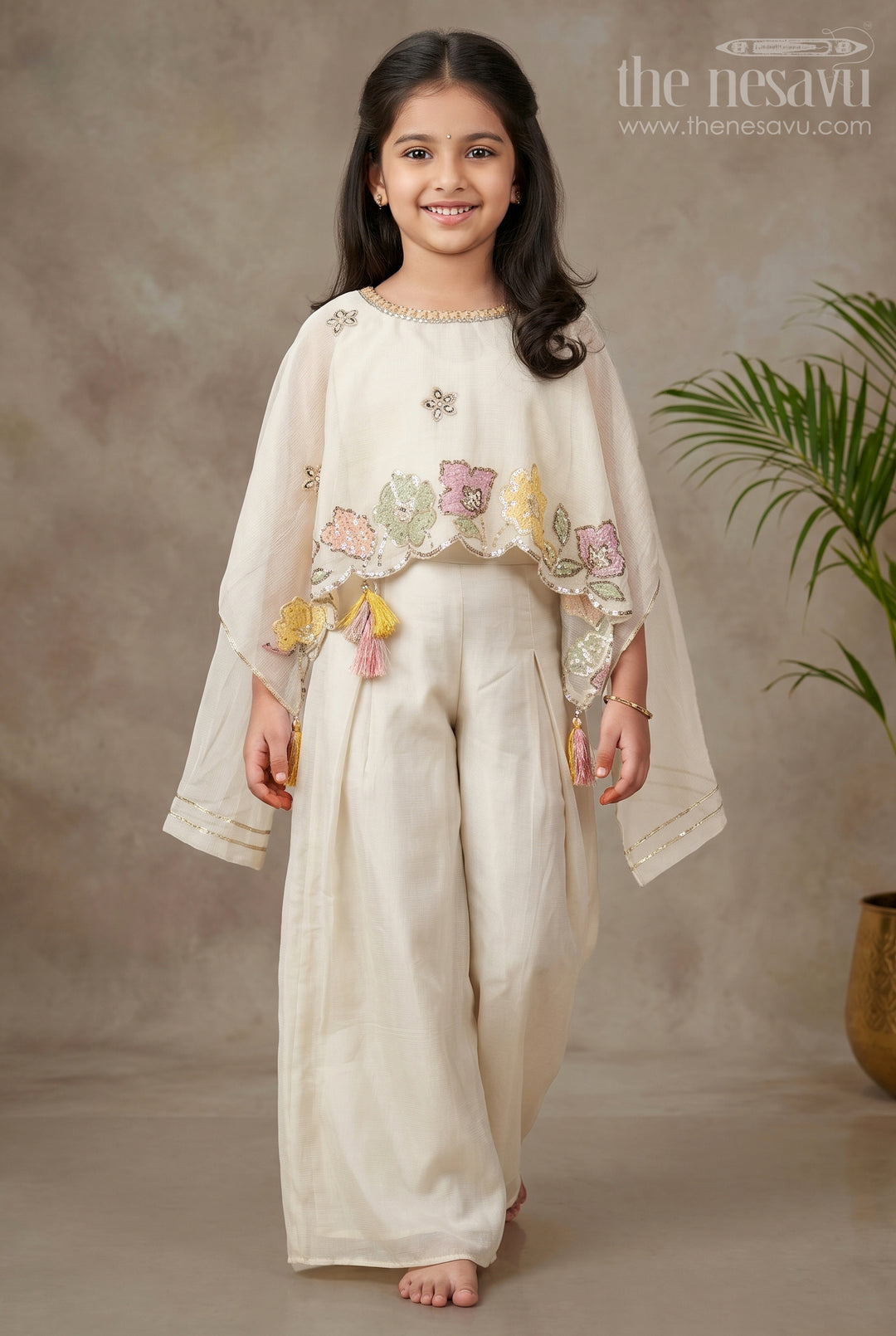 The Nesavu Girls Sharara / Plazo Set Cream Color Sharara Set for Girls in Shimmer Viscose Silk with Designer Embroidered Cape and Tassels Nesavu 16 (1Y) / Cream GPS599A-16 Girls Cream Color Sharara Set Embroidered Shimmer Cape Top Flared Silk Pants | The Nesavu