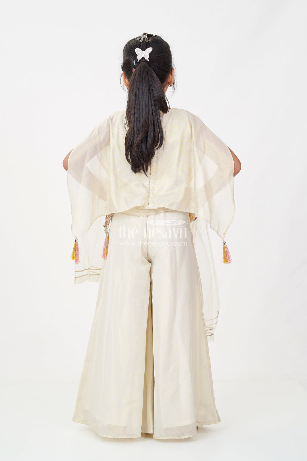 The Nesavu Girls Sharara / Plazo Set Cream Color Sharara Set for Girls in Shimmer Viscose Silk with Designer Embroidered Cape and Tassels Nesavu Girls Cream Color Sharara Set Embroidered Shimmer Cape Top Flared Silk Pants | The Nesavu