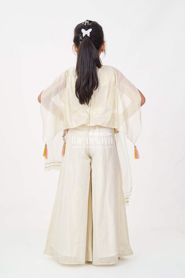 The Nesavu Girls Sharara / Plazo Set Cream Color Sharara Set for Girls in Shimmer Viscose Silk with Designer Embroidered Cape and Tassels Nesavu Girls Cream Color Sharara Set Embroidered Shimmer Cape Top Flared Silk Pants | The Nesavu