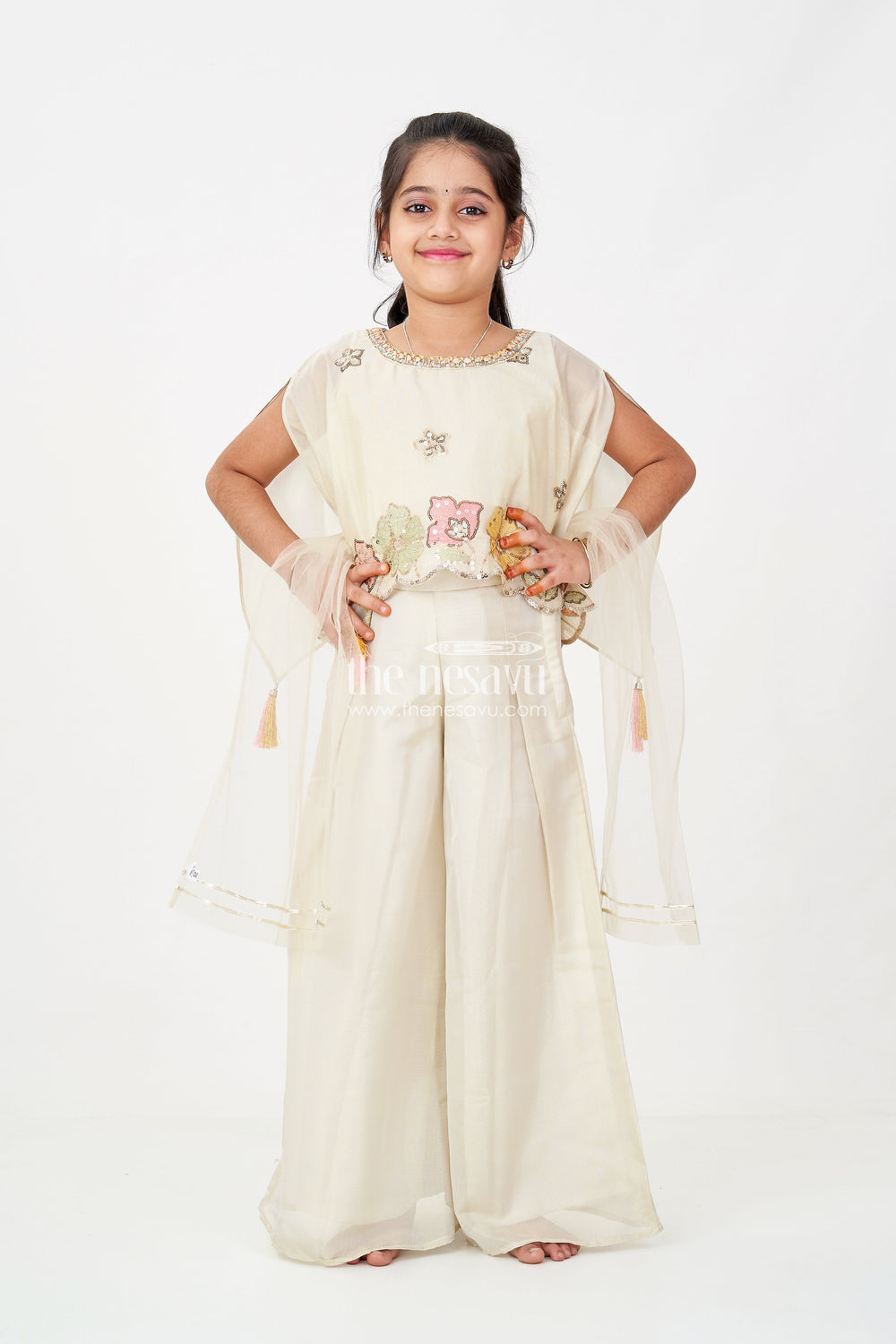 The Nesavu Girls Sharara / Plazo Set Cream Color Sharara Set for Girls in Shimmer Viscose Silk with Designer Embroidered Cape and Tassels Nesavu Nesavu Girls Cream Color Sharara Set Embroidered Shimmer Cape Top Flared Silk Pants