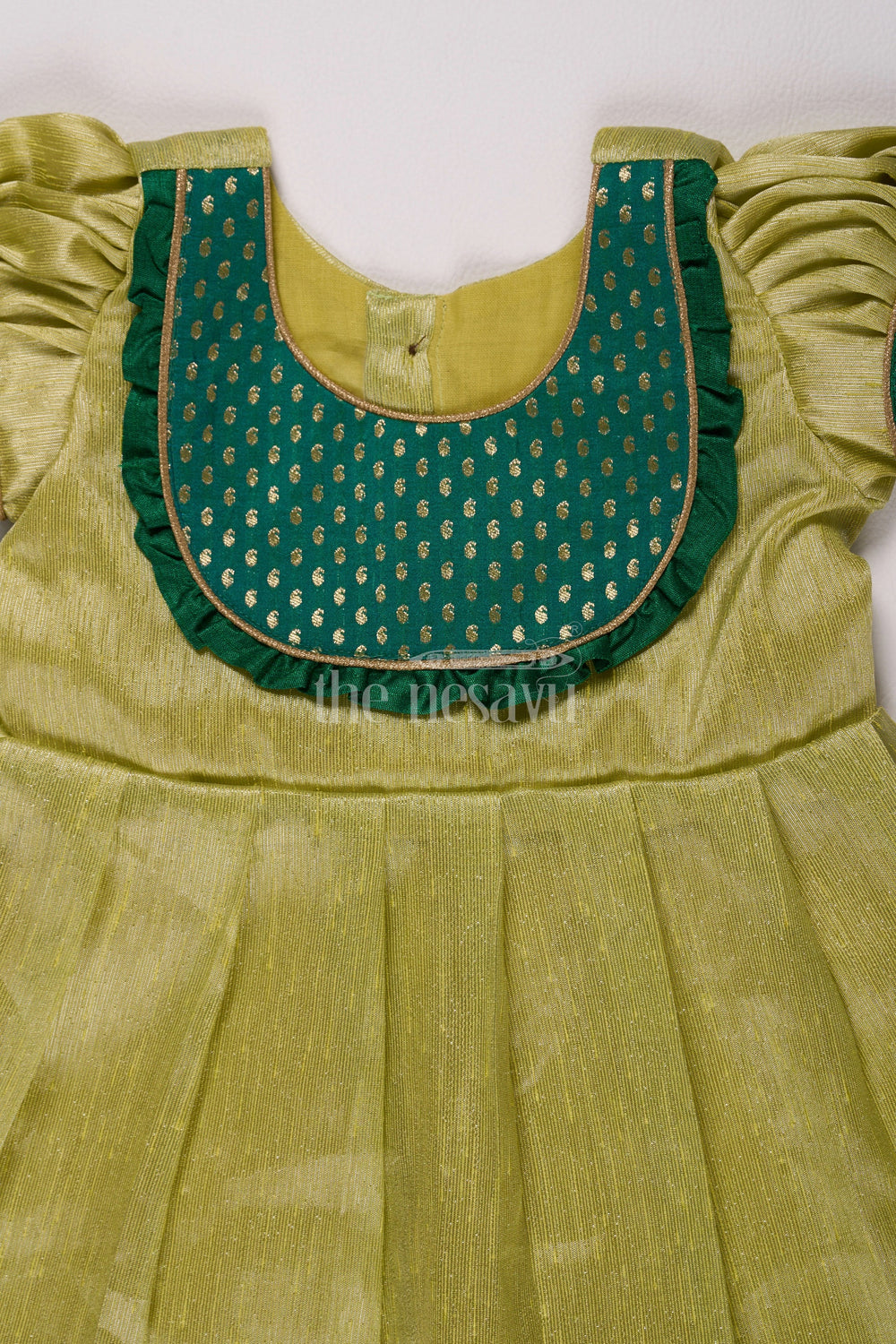 The Nesavu Silk Frock Elegant Light Green Frock Pattu for Girls with Silver Tissue and Golden Yoke Nesavu Nesavus Light Green Frock Pattu Girls Silver Tissue Festive Golden Detailing