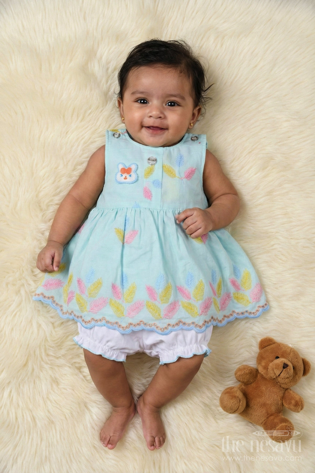 The Nesavu Baby Cotton Frocks Embroidered Baby Frock and Bloomer Set with Playful Leaf Detailing Nesavu Baby frock and bloomer set with multicolor leaf embroidery and character motif