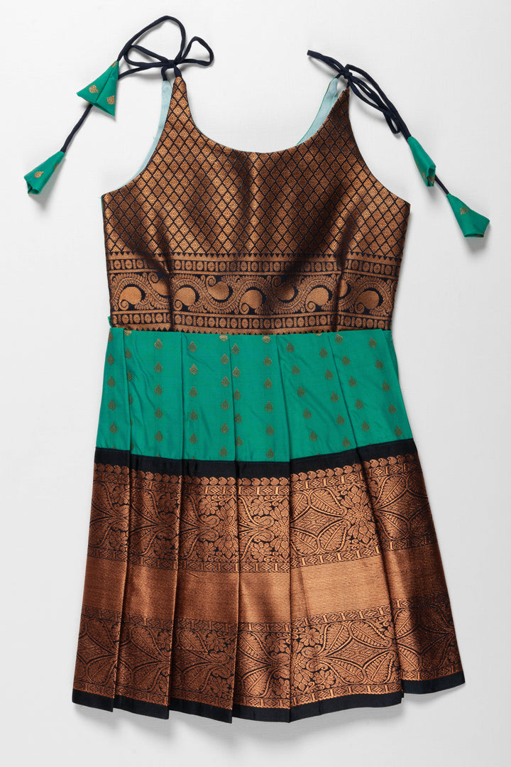 The Nesavu Tie-up Frock Enchanting Green and Bronze Silk Knot-Tie Frock for Ayush Homam and Noolukettu: A Blend of Tradition Nesavu 14 (6M) / Green / Style 2 T378B-14 Chic Green and Bronze Silk Dresses for Girls | Elegant Party Wear with KnotTie Detail | The Nesavu