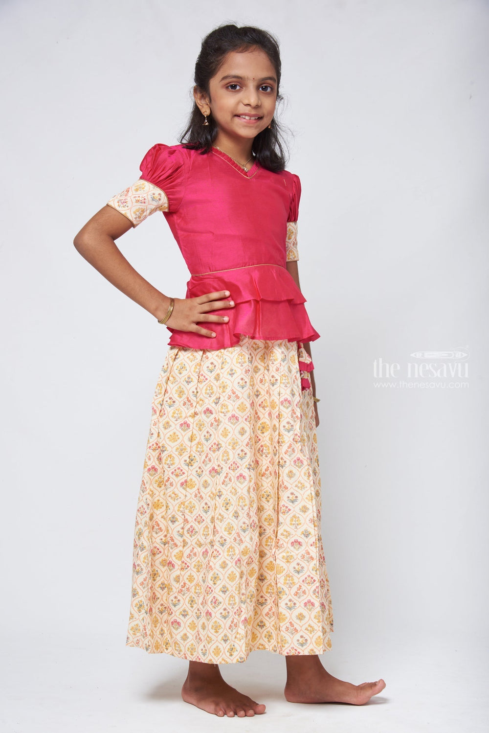 The Nesavu Pattu Pavadai Floral Printed Beige Skirt with Pink Jacquard Peplum Blouse Nesavu Kanchipuram Pattu Pavadai | Silk Dress for Girls | The Nesavu