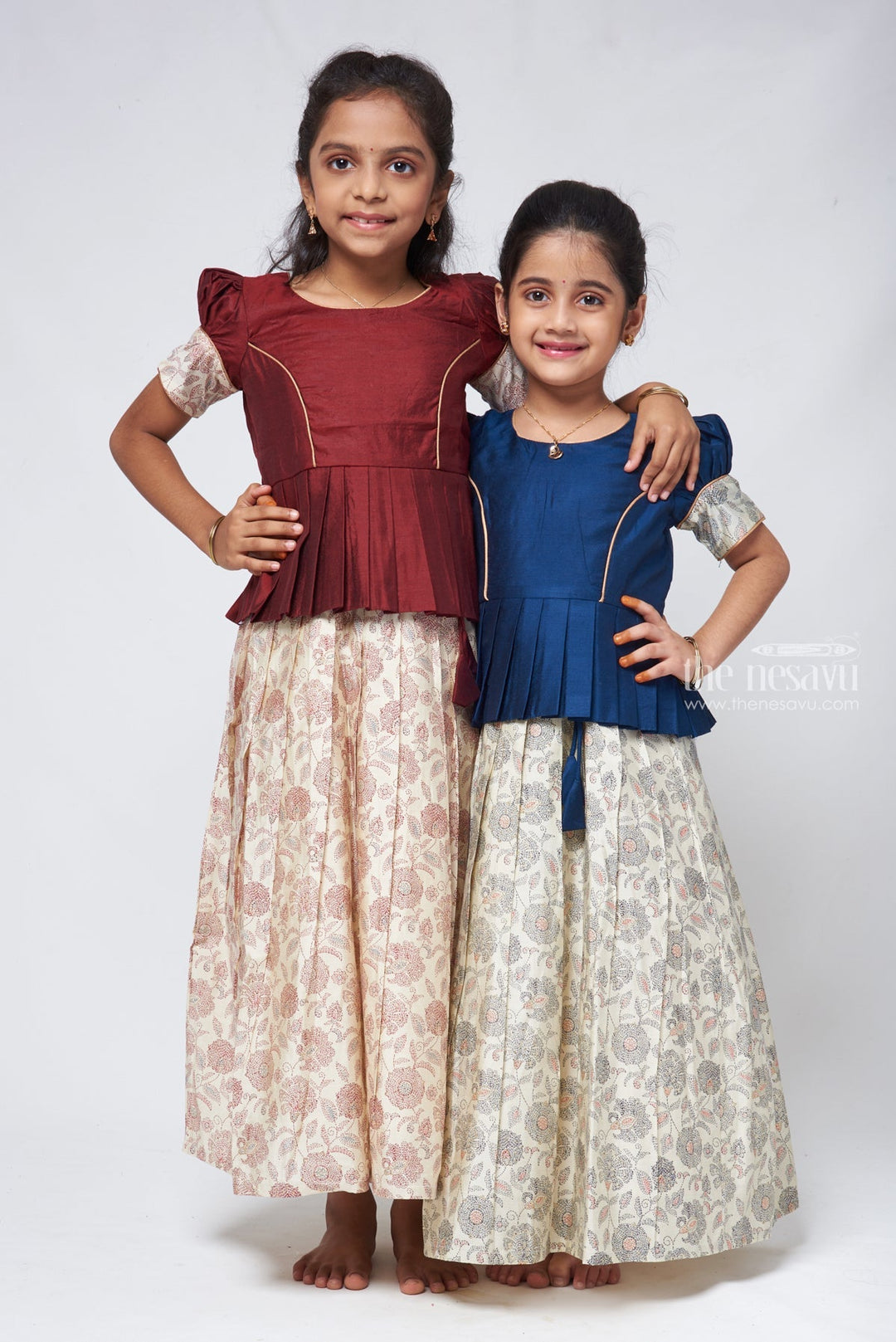 The Nesavu Pattu Pavadai Floral Printed Pleated Beige Skirt with Box Pleated Brown Jacquard Silk Blouse for Girls Nesavu Latest Pattu Pavadai Designs | Girls Pattu Langa | The Nesavu