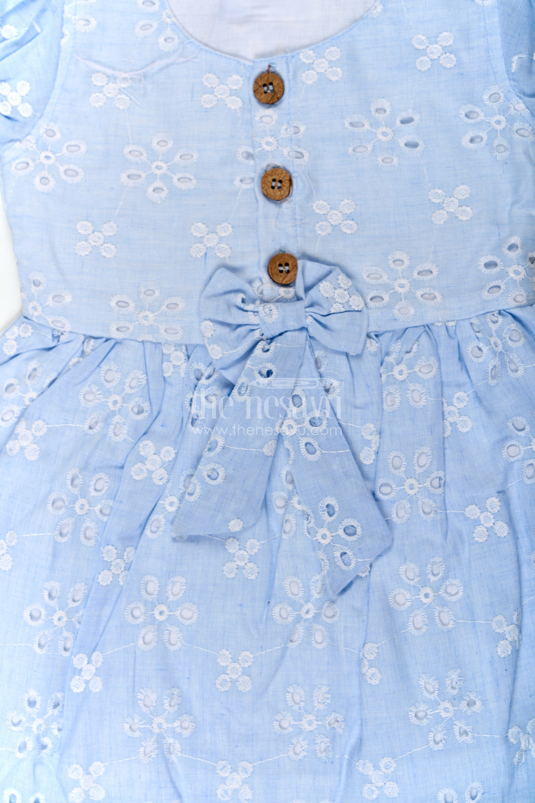 The Nesavu Girls Cotton Frock Girls Casual Wear Party Dress in Sky Blue Hakoba with Bow Belt and Wooden Button Detail Nesavu Casual Wear Party Dress for Girls in Sky Blue Hakoba with Embroidery and Waist Bow | The Nesavu