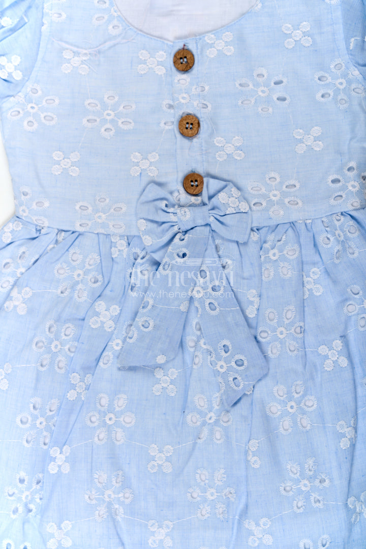 The Nesavu Girls Cotton Frock Girls Casual Wear Party Dress in Sky Blue Hakoba with Bow Belt and Wooden Button Detail Nesavu Casual Wear Party Dress for Girls in Sky Blue Hakoba with Embroidery and Waist Bow | The Nesavu