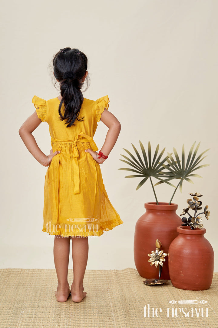 The Nesavu Girls Chanderi Frock Girls Chanderi Cotton Simple Frock Design with Swing Embroidery and Frill Sleeves in Honey Yellow Nesavu Nesavu Girls Chanderi Cotton Honey Yellow Frock Swing Motif Simple Frill Sleeve Design