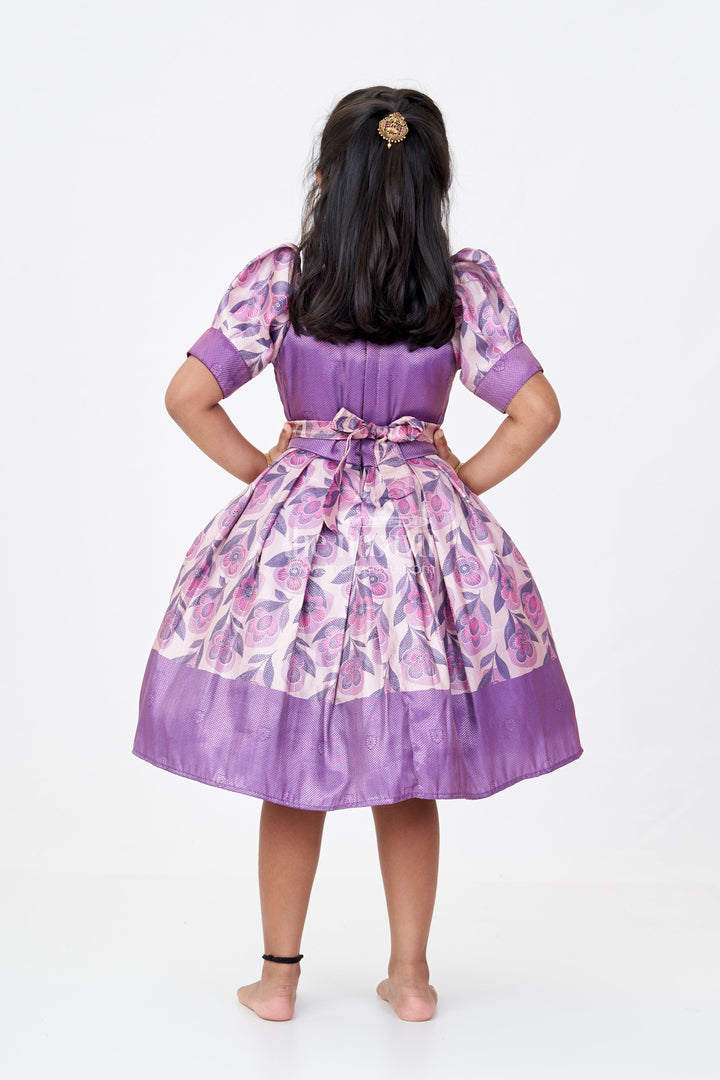 The Nesavu Silk Frock Girls Cotton Silk Frock in Rich Purple Jacquard with Floral Border and Embellished Neckline Nesavu Girls Cotton Silk Frock Purple Jacquard Floral Print Border Embellished Neckline | The Nesavu