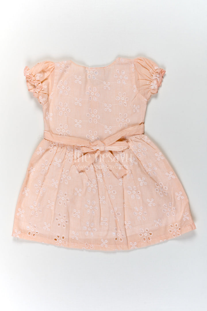 The Nesavu Girls Cotton Frock Girls Cotton Sleeveless Dress in Pastel Peach with All-Over Hakoba Floral Embroidery Nesavu Cotton Sleeveless Dress for Girls in Peach Hakoba Fabric with Embroidery and Button Detail | The Nesavu