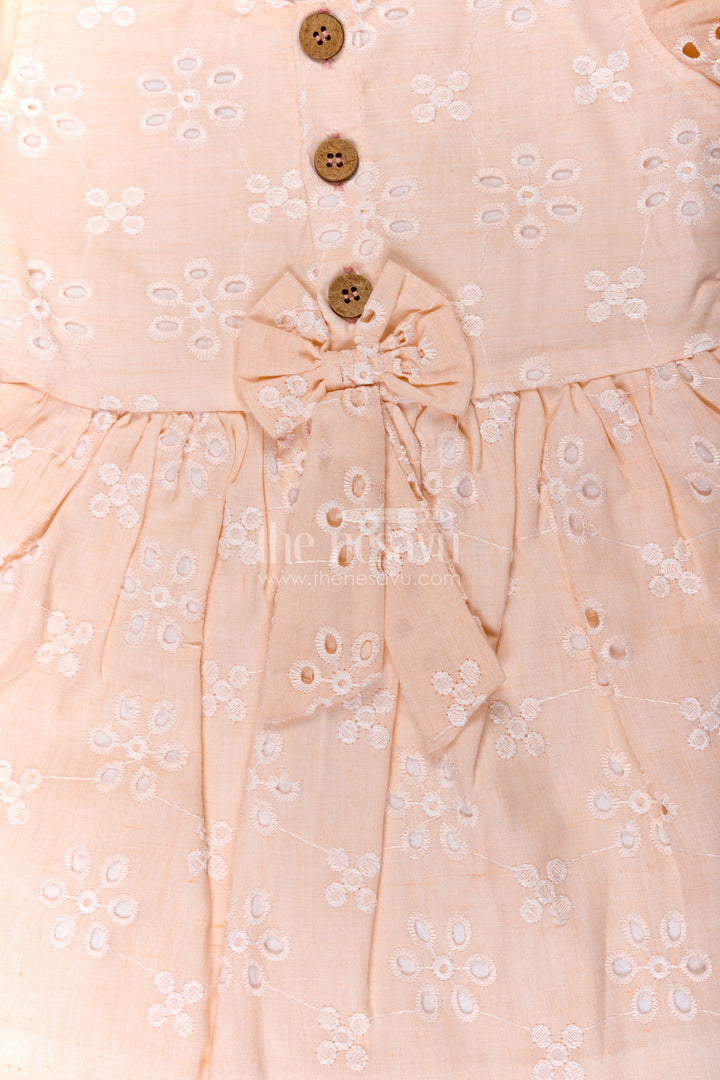 The Nesavu Girls Cotton Frock Girls Cotton Sleeveless Dress in Pastel Peach with All-Over Hakoba Floral Embroidery Nesavu Cotton Sleeveless Dress for Girls in Peach Hakoba Fabric with Embroidery and Button Detail | The Nesavu