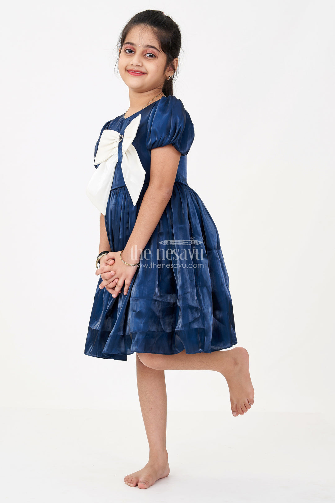 The Nesavu Girls Fancy Frock Girls Disney Princess Frock in Navy Blue Satin with Puff Sleeves and Large Ivory Bow Embellishment Nesavu 20 (3Y) / Blue GFC1670A-20 Girls Disney Princess Frock Satin Puff Sleeves Royal Bow Embellishment | The Nesavu