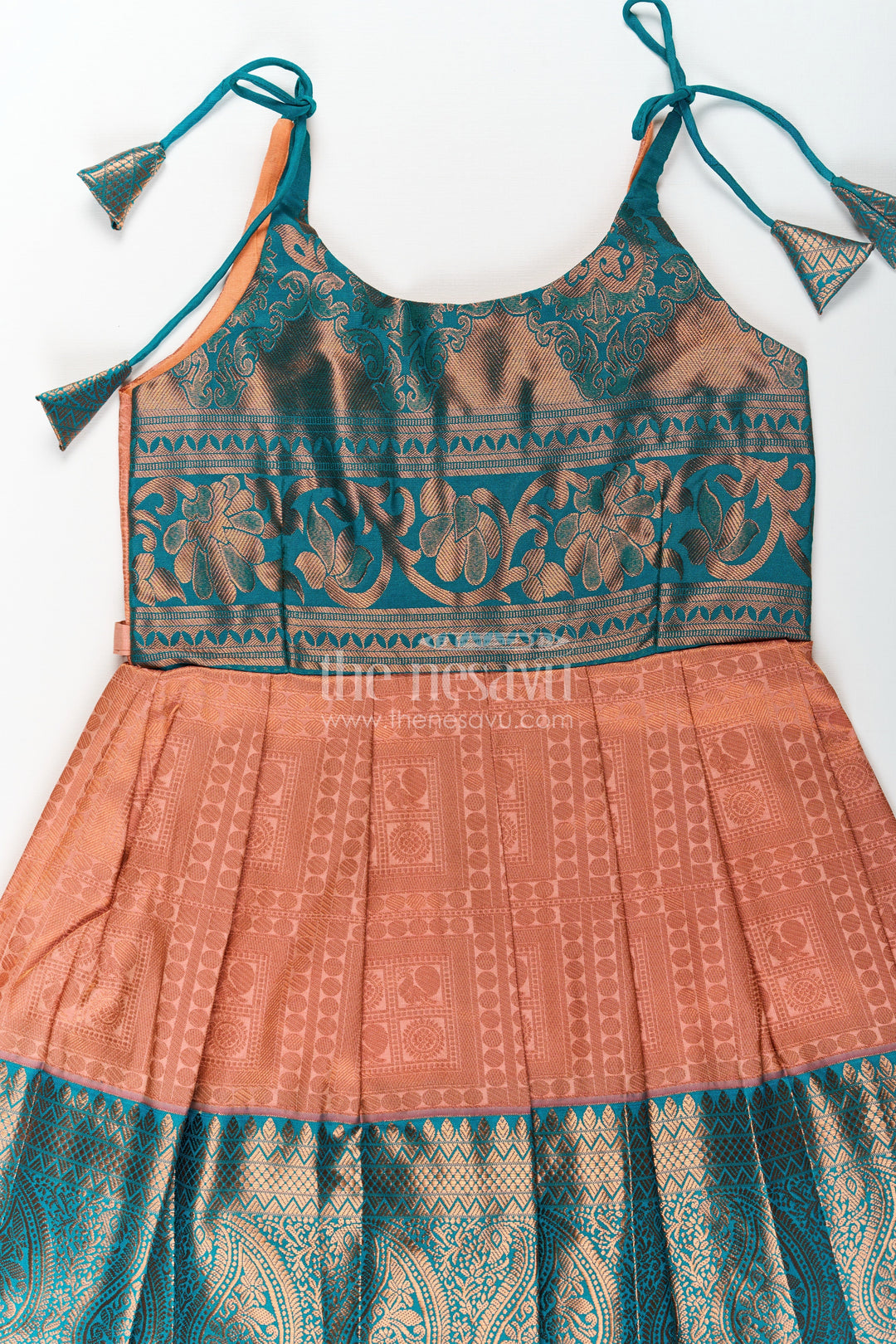 The Nesavu Tie-up Frock Girls Ethnic Silk Dresses in Semi Kanchivaram with Tie Up Sleeves and Zari Woven Orange Green Pleated Skirt Nesavu Ethnic Silk Dresses for Girls in Semi Kanchivaram with Orange Green Zari Pleated Tie Up Frock | The Nesavu