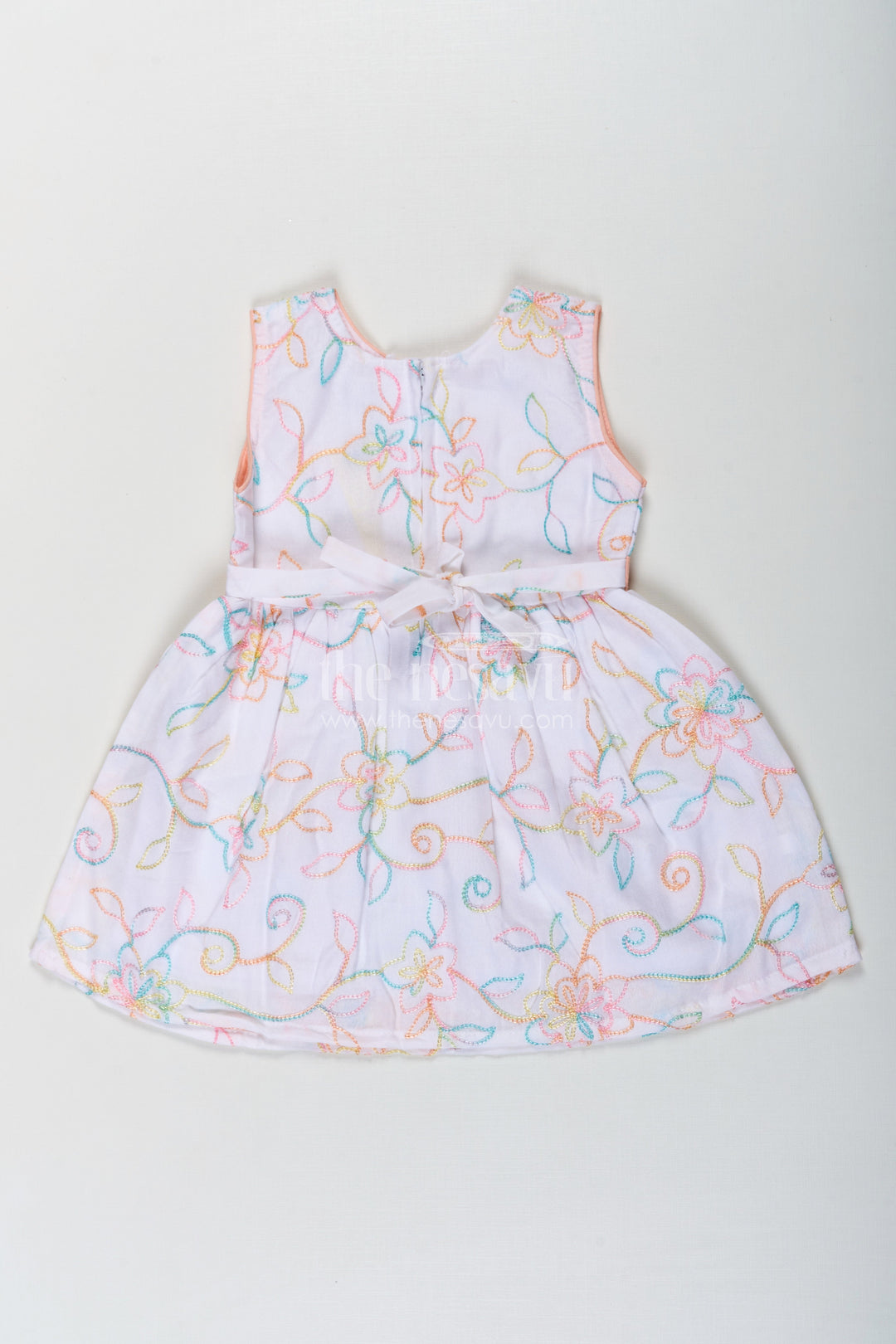 The Nesavu Baby Cotton Frocks Girls Flower White Dress in Cotton with Multicolor Floral Embroidery and Peach Waist Bow Nesavu Flower White Dress Girls Embroidered Cotton Multicolor Floral Patterns Bow Accent | The Nesavu