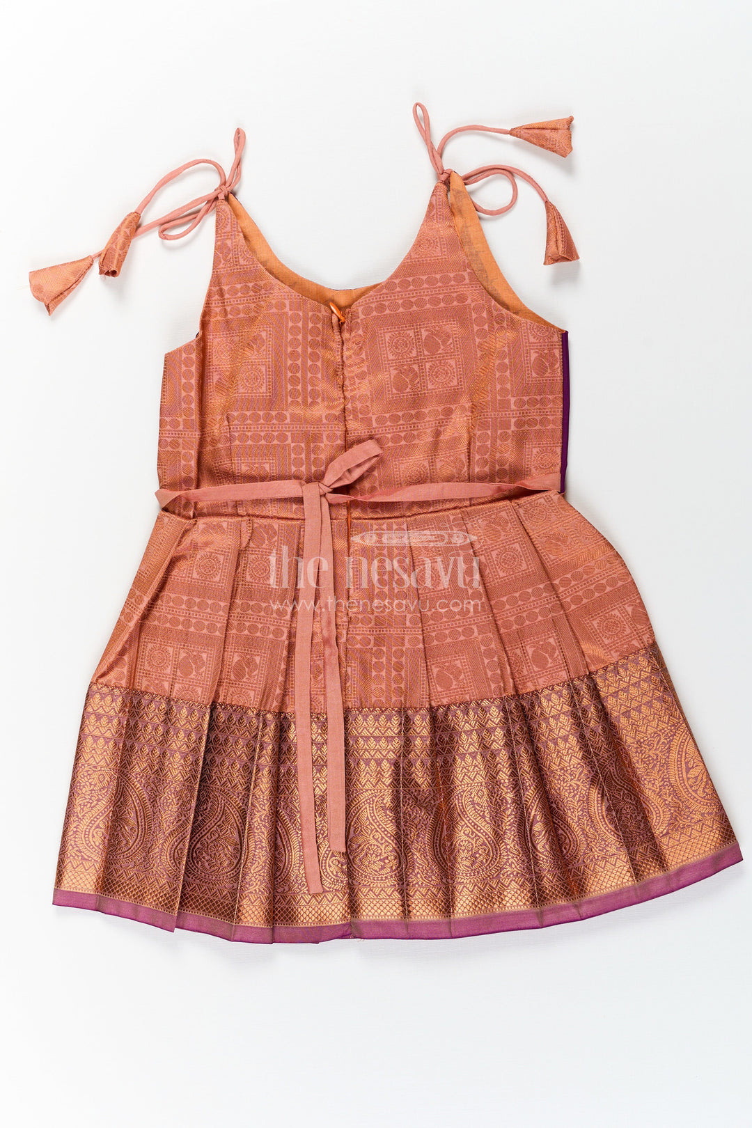 The Nesavu Tie Up Frock Girls Gold Silk Dress in Semi Kanchivaram with Purple Zari Bodice and Pleated Tie Up Tassel Frock Nesavu Nesavu Gold Silk Dress for Girls in Semi Kanchivaram with Purple Zari Weave and Tassel Tie Up Straps