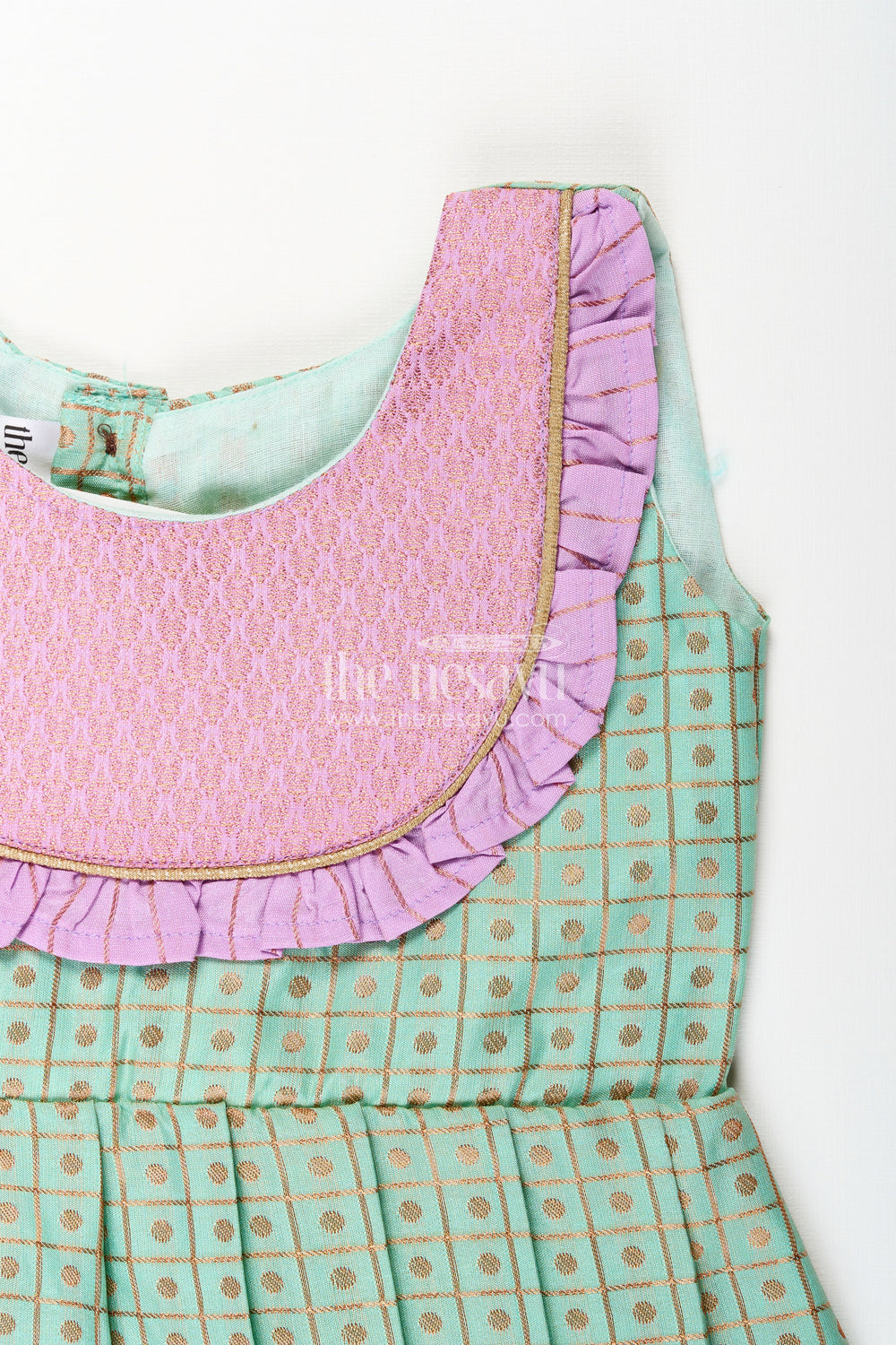 The Nesavu Girls Kanchi Silk Frock Girls Green Semi Kanchivaram Silk Frock with Lavender Border Nesavu Nesavu girls green semi Kanchivaram silk frock with lavender border and frill yoke