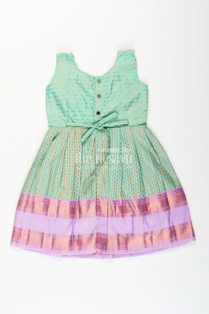 The Nesavu Girls Kanchi Silk Frock Girls green semi Kanchivaram silk frock with lavender border Nesavu Nesavu girls green semi Kanchivaram silk frock with lavender border and frill yoke