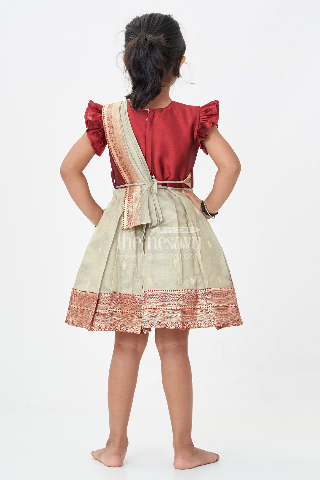 The Nesavu Silk Party Frock Girls Infant Baptism Dress in Maroon and Gold with Pleated Silk Skirt and Puff Sleeves for Graceful Looks Nesavu Girls Silk Infant Baptism Dress Zari Border Puff Sleeves Maroon Gold | The Nesavu