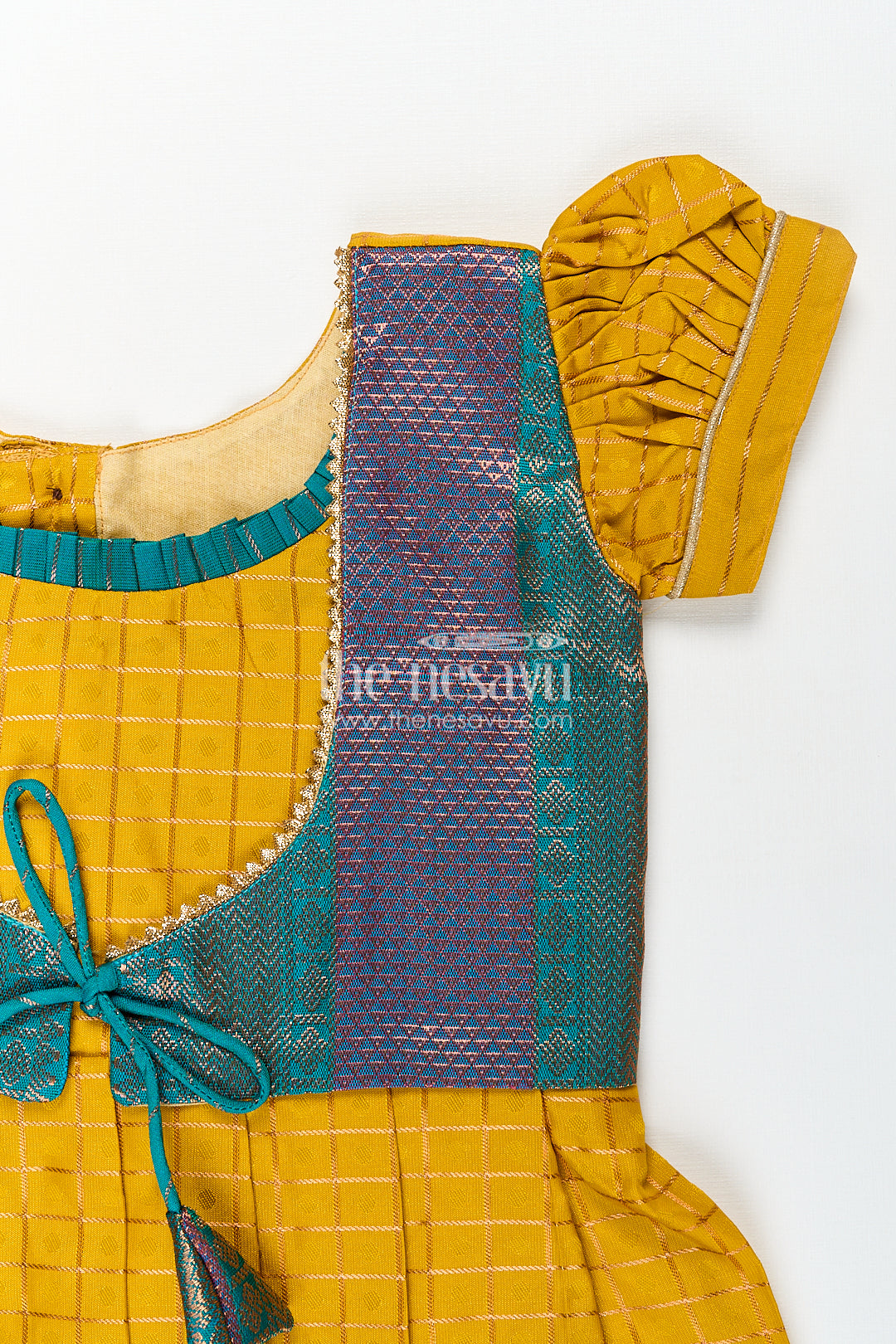 The Nesavu Girls Kanchi Silk Frock Girls Kanchivaram Ethnic Frocks in Mustard Yellow with Green Zari Overlay and Traditional Border Accents Nesavu Nesavu Girls Ethnic Frocks Mustard Green Kanchivaram Silk Zari Border Puff Sleeves