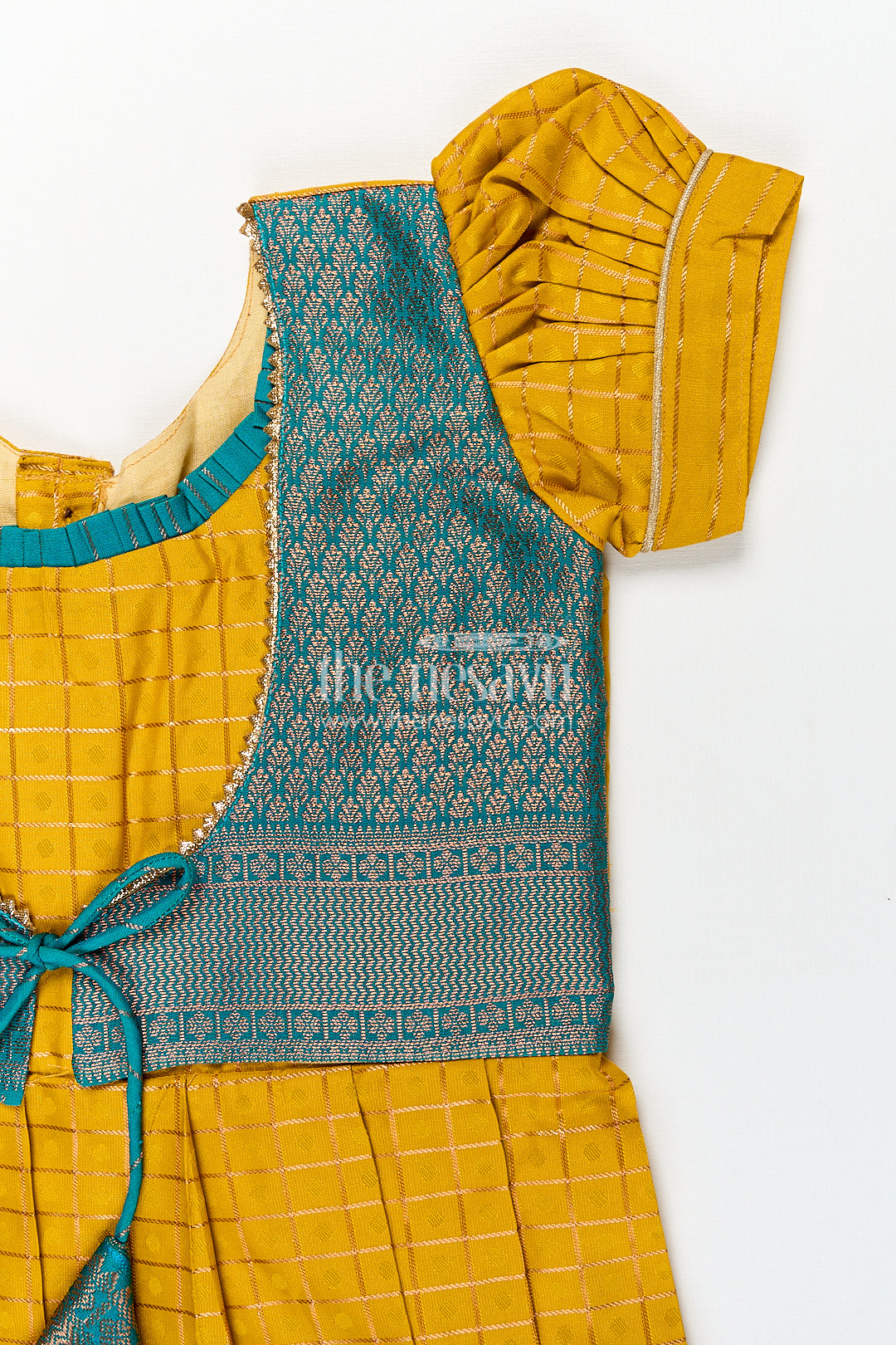 The Nesavu Girls Kanchi Silk Frock Girls Kanchivaram Ethnic Frocks in Mustard Yellow with Green Zari Overlay and Traditional Border Accents Nesavu Nesavu Girls Ethnic Frocks Mustard Green Kanchivaram Silk Zari Border Puff Sleeves