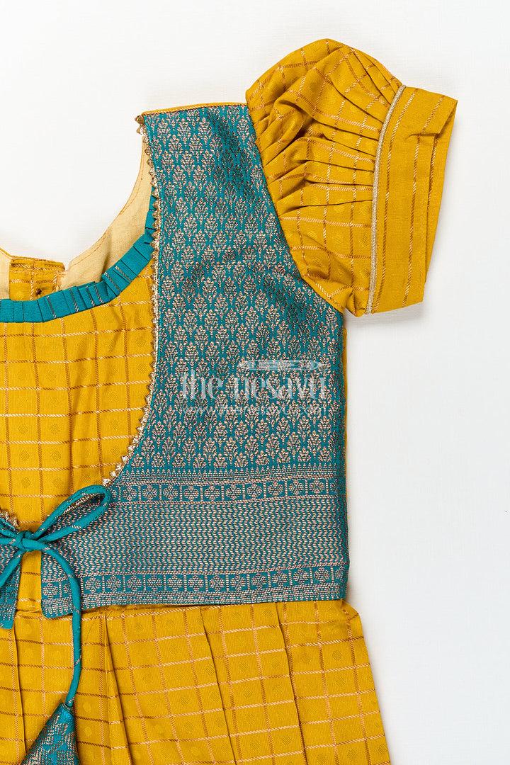 The Nesavu Girls Kanchi Silk Frock Girls Kanchivaram Ethnic Frocks in Mustard Yellow with Green Zari Overlay and Traditional Border Accents Nesavu Nesavu Girls Ethnic Frocks Mustard Green Kanchivaram Silk Zari Border Puff Sleeves