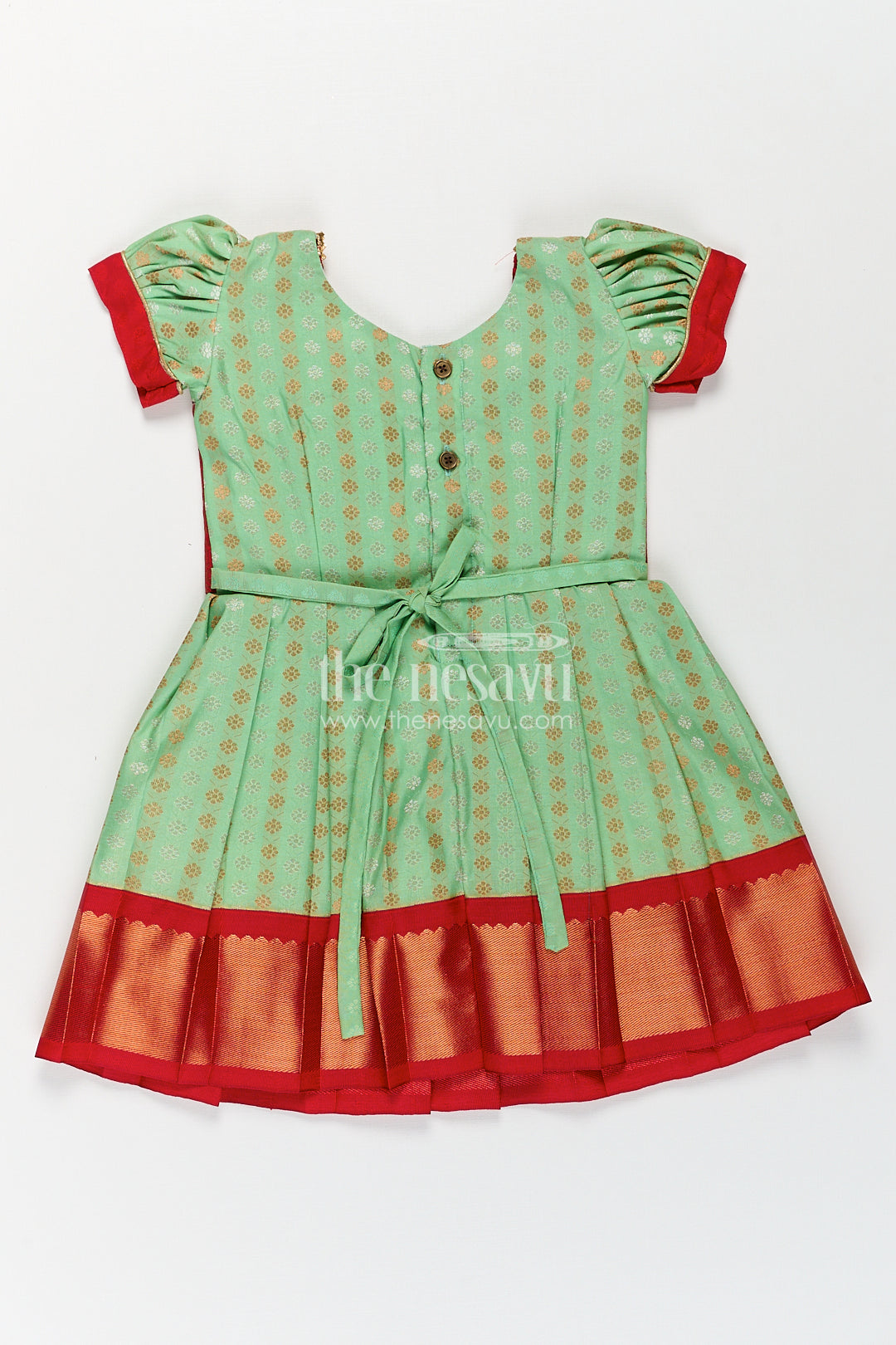 The Nesavu Girls Kanchi Silk Frock Girls Kanchivaram Pattu Saree Long Frock with Puff Sleeves in Green and Red Zari Woven Traditional Style Nesavu Nesavu Girls Pattu Saree Long Frock Kanchivaram Silk Green Body Red Zari Pleated Border