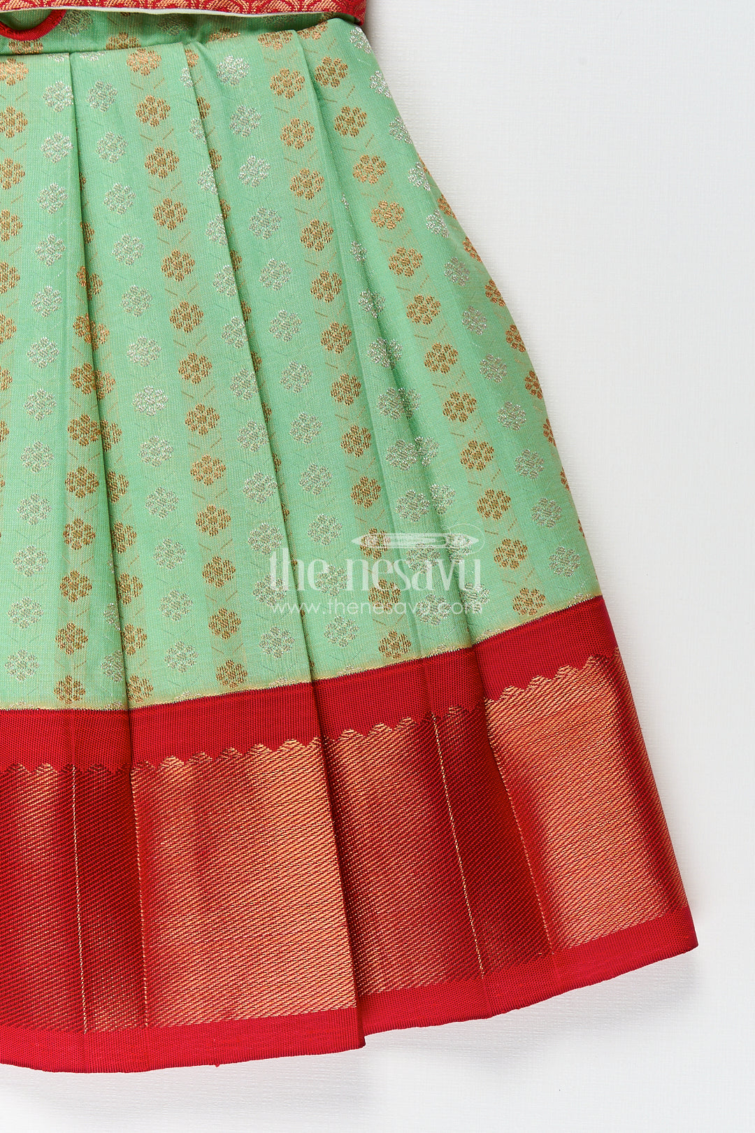 The Nesavu Girls Kanchi Silk Frock Girls Kanchivaram Pattu Saree Long Frock with Puff Sleeves in Green and Red Zari Woven Traditional Style Nesavu Nesavu Girls Pattu Saree Long Frock Kanchivaram Silk Green Body Red Zari Pleated Border