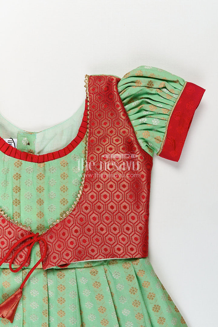 The Nesavu Girls Kanchi Silk Frock Girls Kanchivaram Pattu Saree Long Frock with Puff Sleeves in Green and Red Zari Woven Traditional Style Nesavu Nesavu Girls Pattu Saree Long Frock Kanchivaram Silk Green Body Red Zari Pleated Border