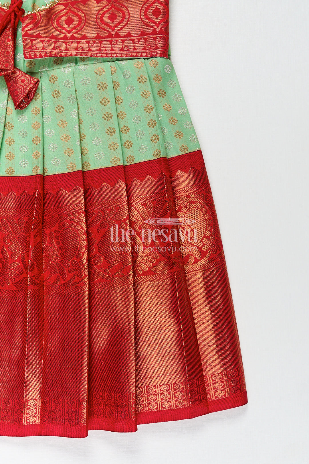 The Nesavu Girls Kanchi Silk Frock Girls Kanchivaram Pattu Saree Long Frock with Puff Sleeves in Green and Red Zari Woven Traditional Style Nesavu Nesavu Girls Pattu Saree Long Frock Kanchivaram Silk Green Body Red Zari Pleated Border